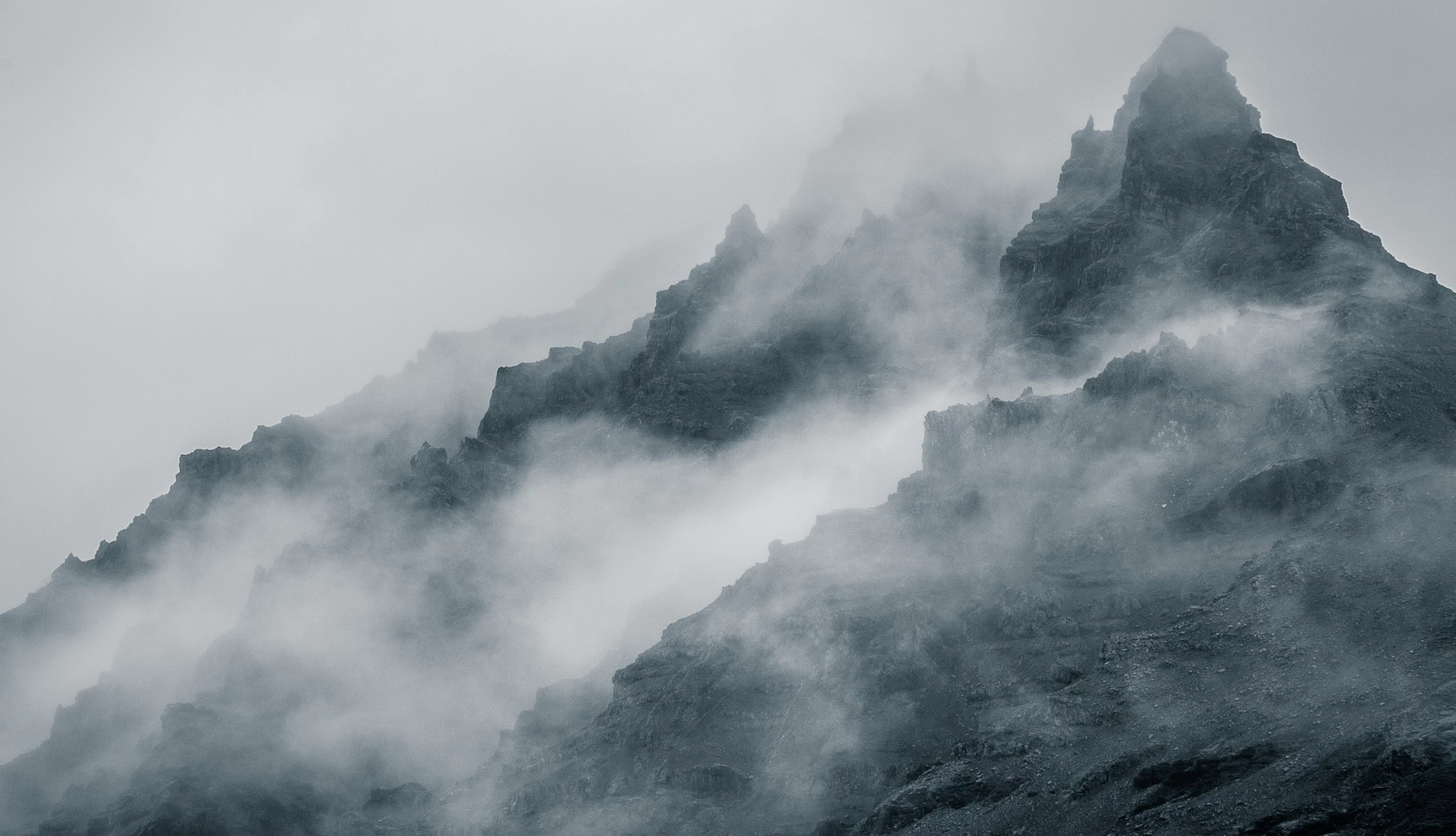 A sharp mountain peak in a mist