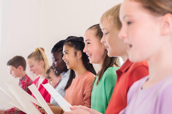 children singing sheet music