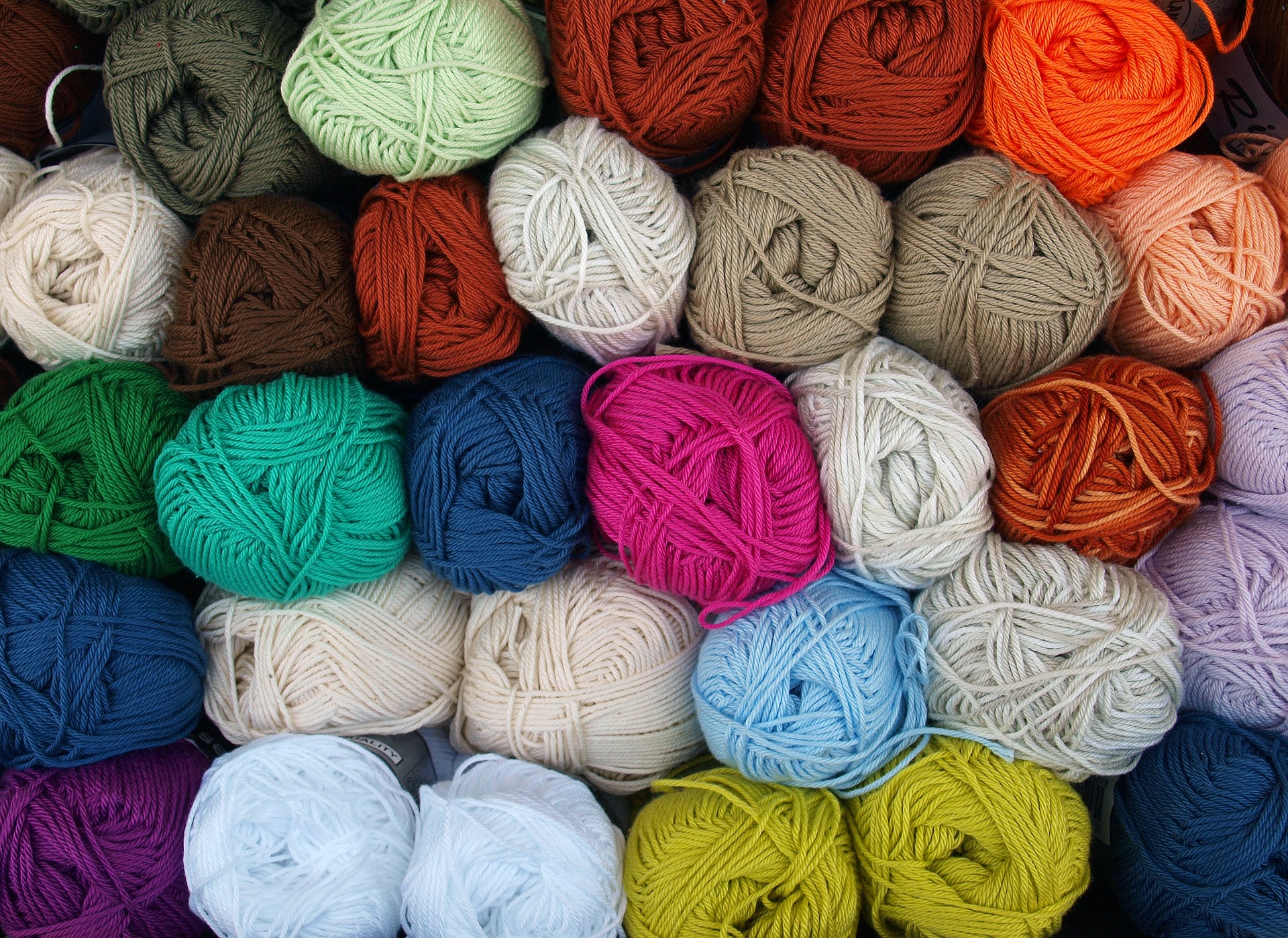 A range of different coloured balls of wool
