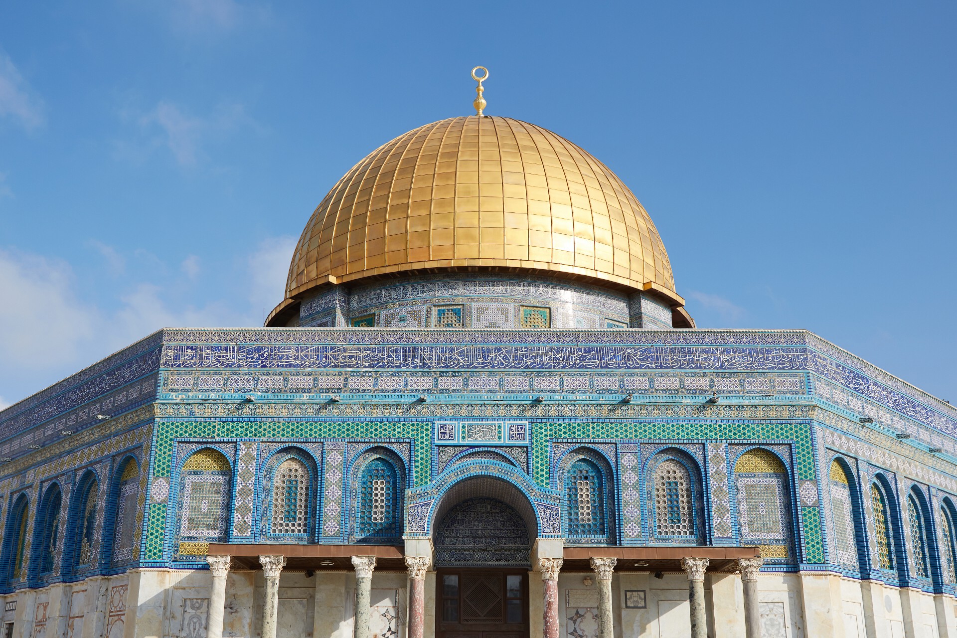 The Dome of the Rock in Jerusalem, featuring the golden dome and intricately designed tiles on the exterior