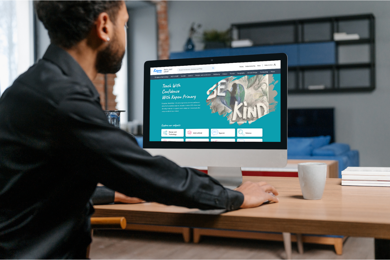 A man sat at his computer looking at the kapow website