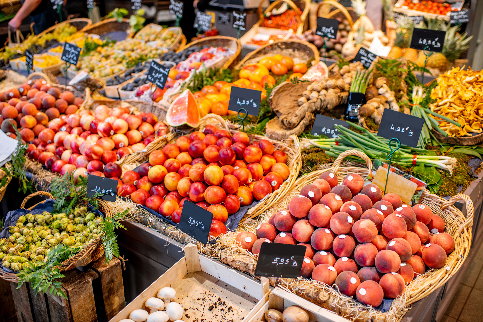 Fresh fruits and vegetables displayed in baskets at a vibrant farmer’s market.