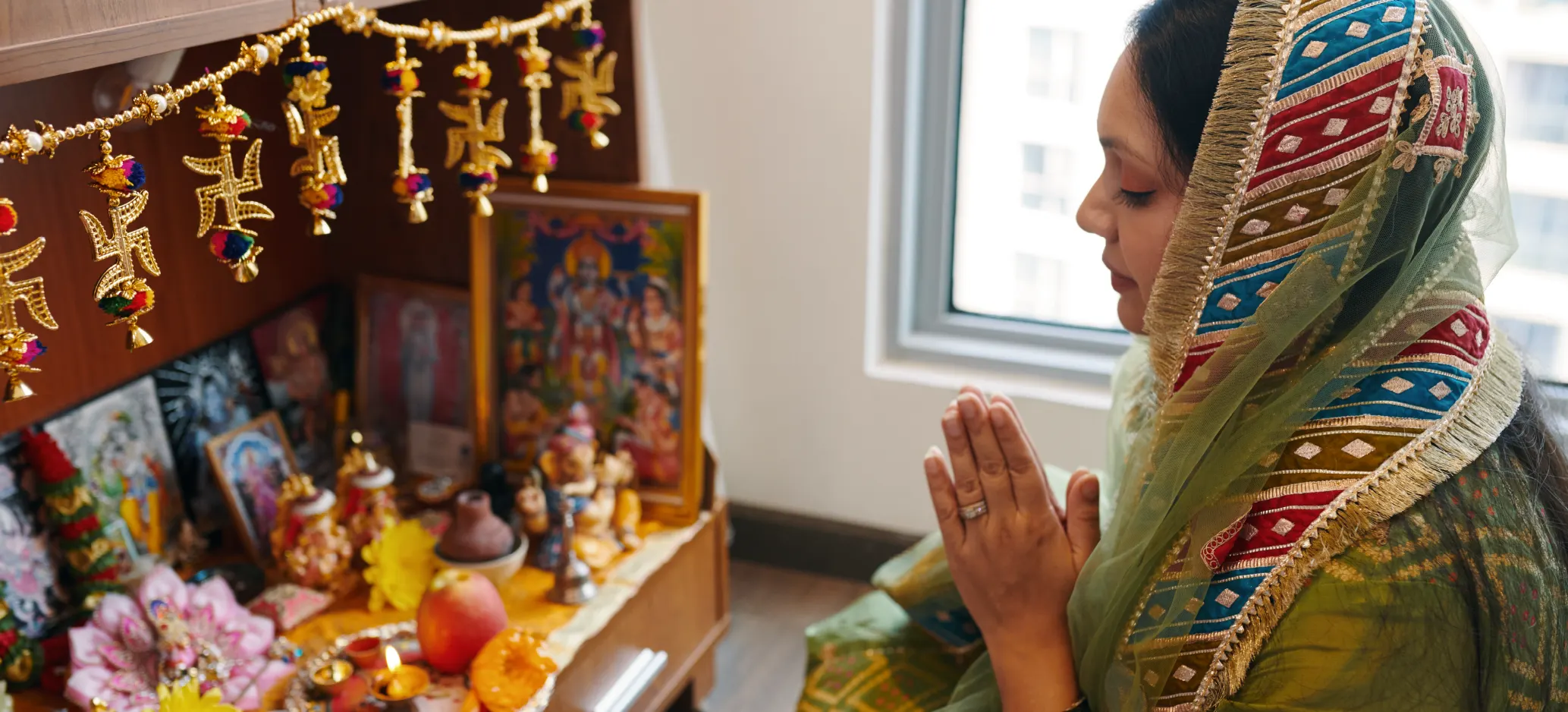 hindu praying woman praying to hindu shrine head covering