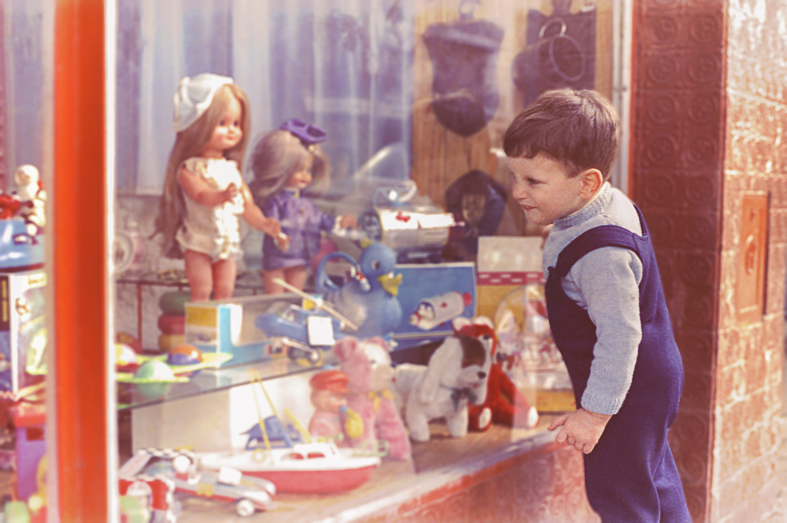 child looking in toy shop