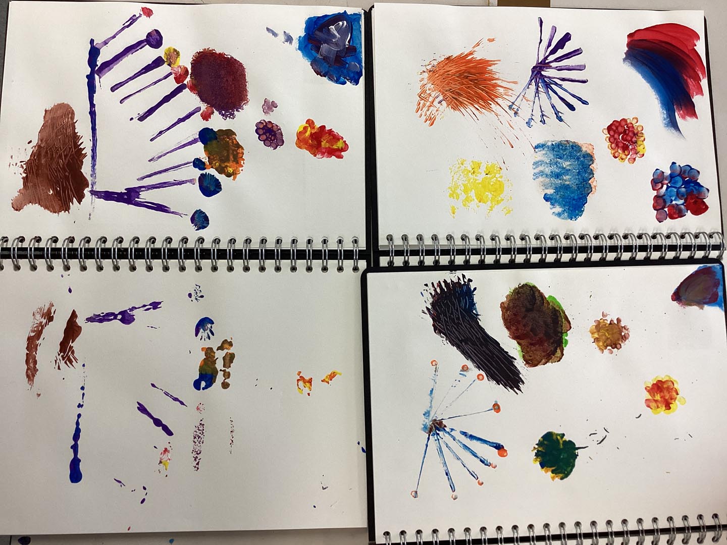 Selection of children's artwork showing their experiments with creating textures with paints