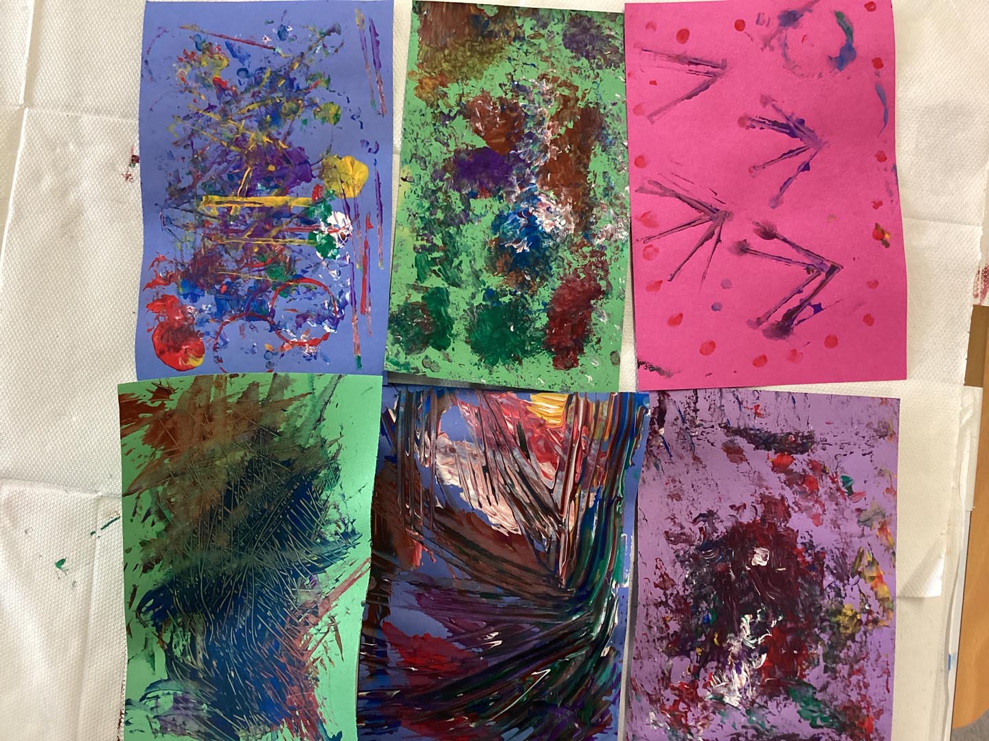 Selection of children's collage papers made on bright coloured paper and painted on to create textures