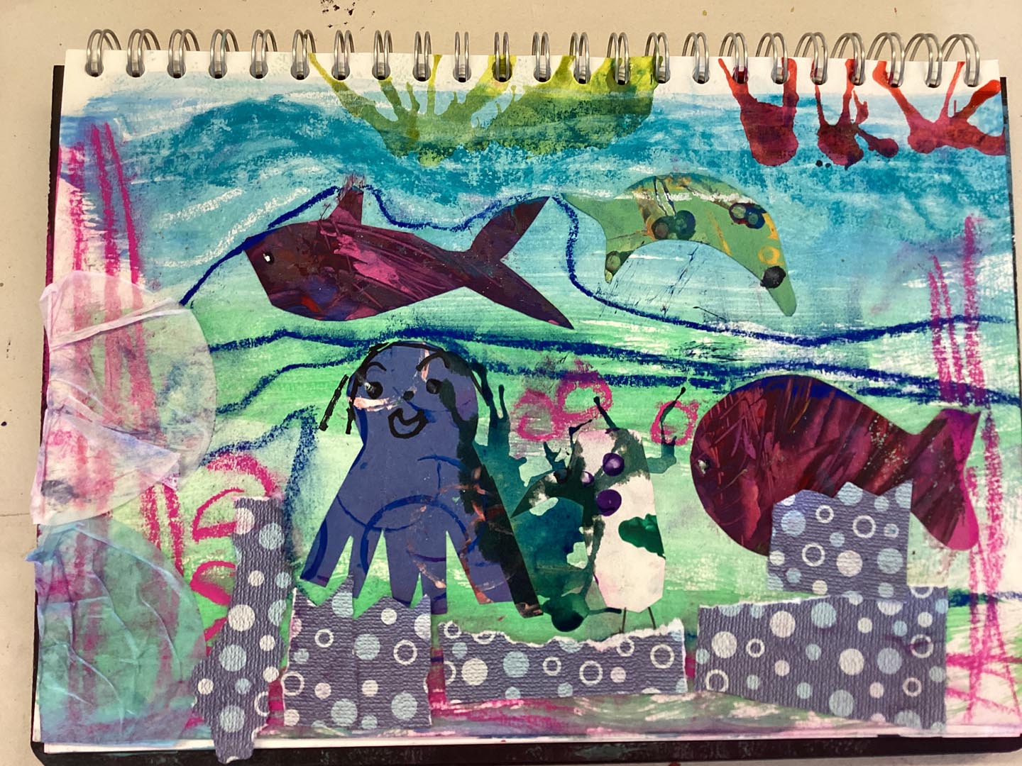 Child created collage using painted textured papers with a sea theme