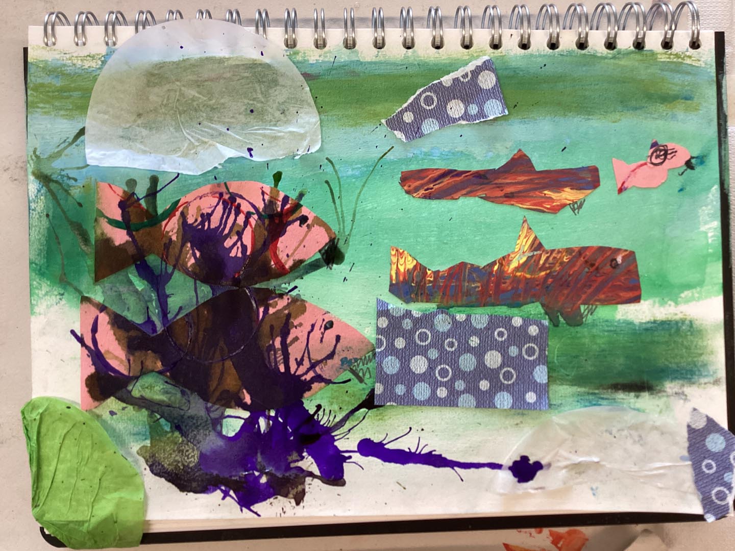 Child created collage using painted textured papers with a sea theme