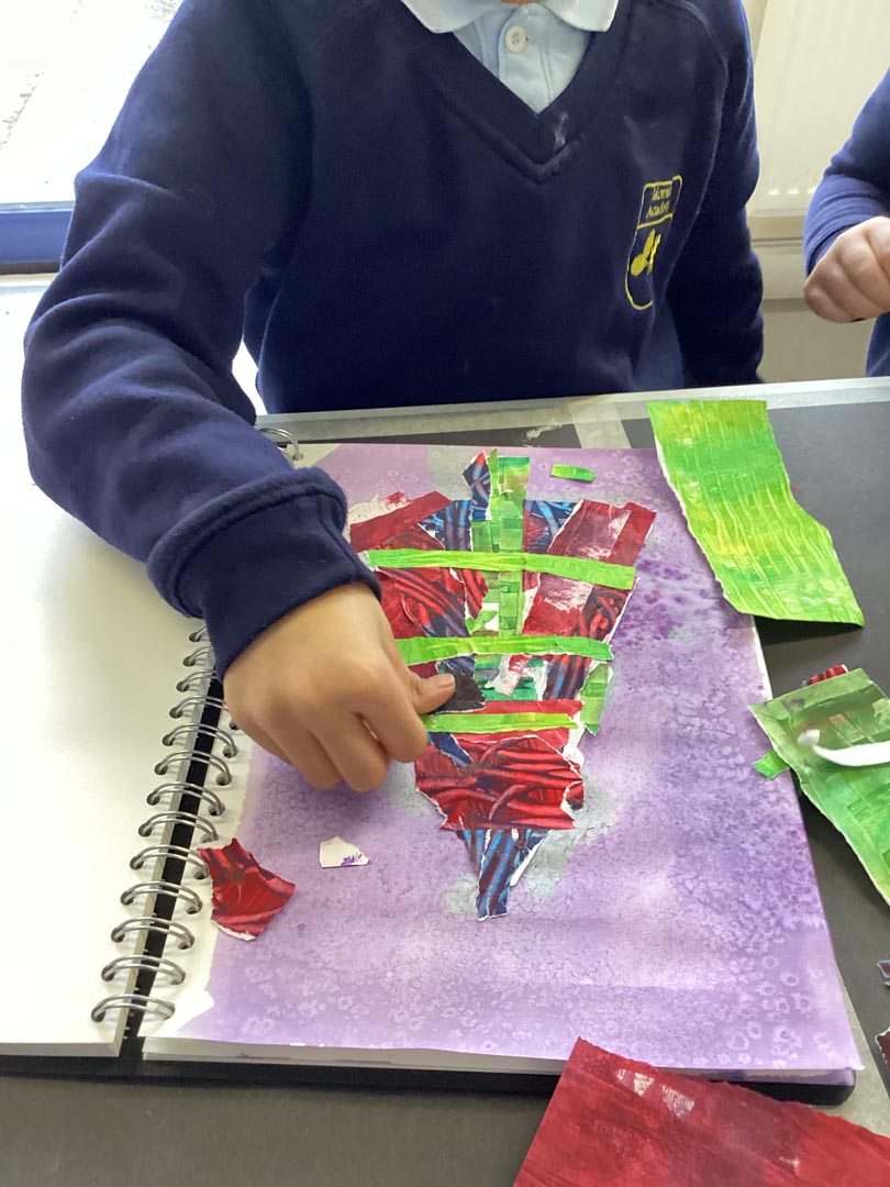 Children creating a collage of a Christmas Tree