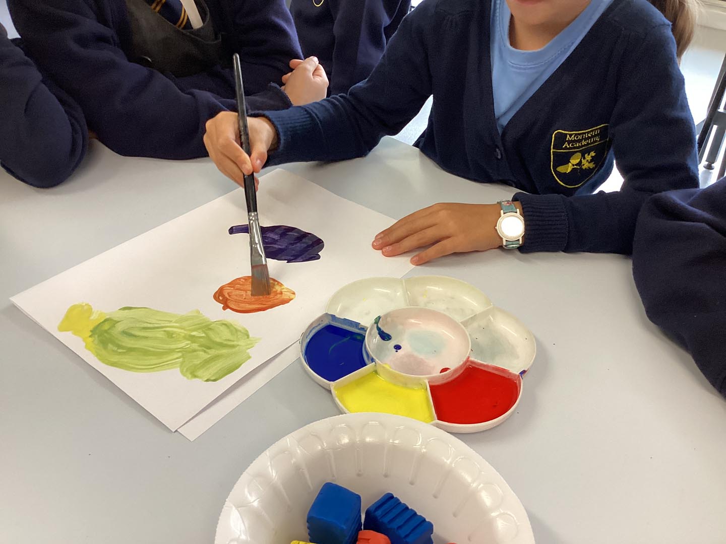 Children painting with primary colours