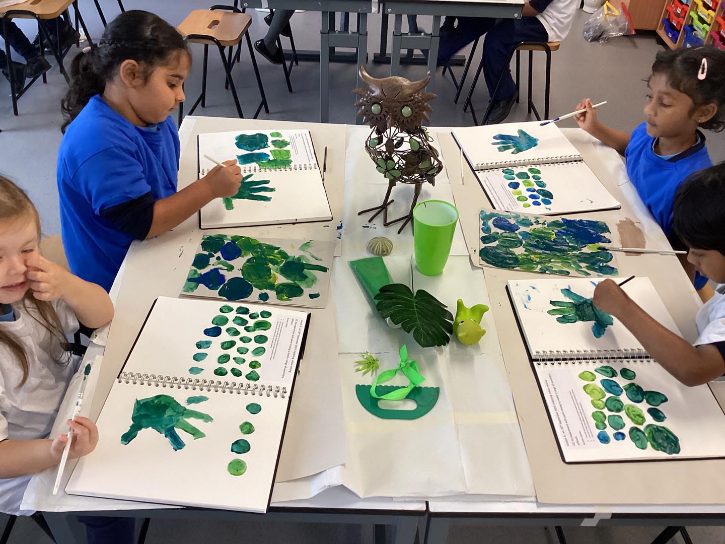 Group of children sitting at a table painting