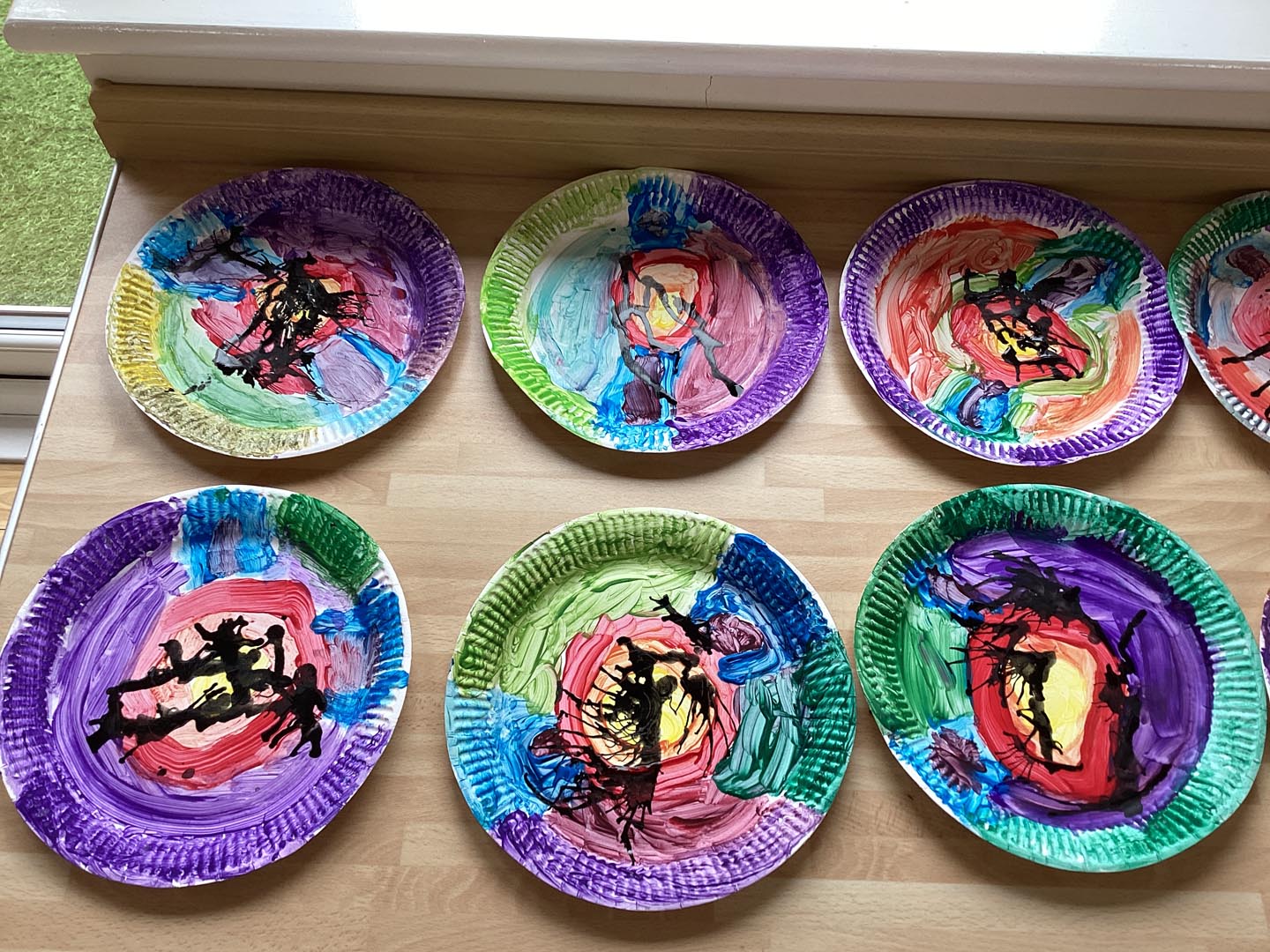 Children's finished paper plate artwork inspired by Clarice Cliff